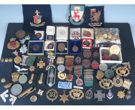 A collection of Army badges, cloth badges, naval and other brass buttons, enamel cross, assorted medallions. 