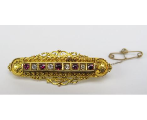 A Victorian 15ct Gold, Ruby and Diamond Brooch set with c. 2.3-2.9mm stones, 48.1mm wide, Chester 1898, 6.39g 