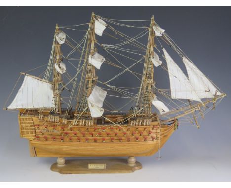 A wood model of HMS Victory, fully rigged, with cotton stitched sails, on a wood stand, 57cm long. 