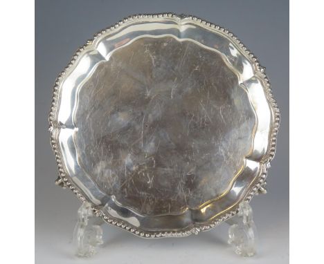 A Victorian silver waiter, maker Henry Wilkinson &amp; Co, London, 1892, with beaded border, raised on three talon and ball f