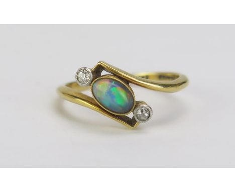 An 18ct Gold and Platinum, Black Opal and Diamond Crossover Ring, 6.2x4.2mm millegrain set singlet flanked by 1.9mm old cuts,