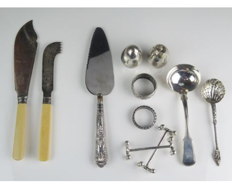 A mixed collection of silver and plated wares includes Fiddle and Thread sauce ladle, sifting spoon, knife rests, napkin ring