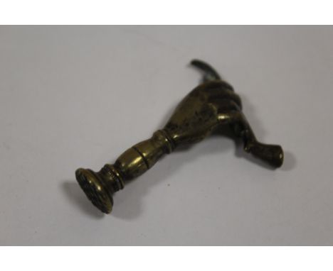 A VINTAGE BRASS PIPE TAMPER IN THE FORM OF A HAND 