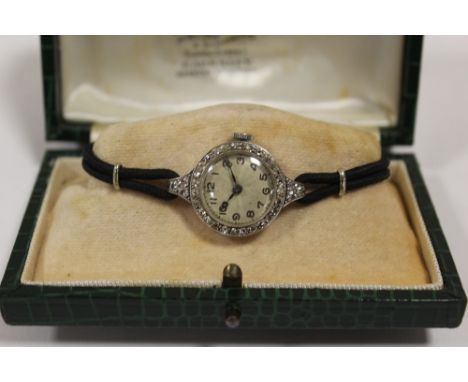 A LADIES VINTAGE PLATINUM AND DIAMOND SET WATCH - EACH BRILLIANT CUT DIAMOND APPROX 0.02 CARATS - TOTAL APPROX 0.60 CARAT
