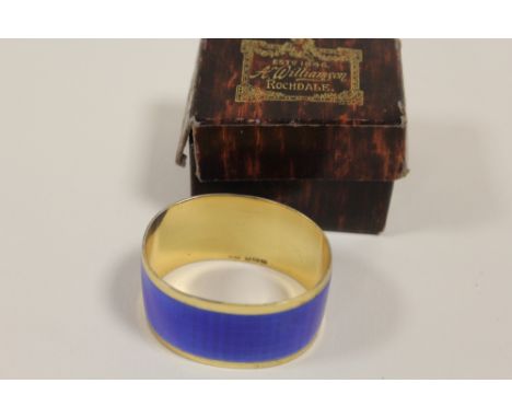 A HALLMARKED SILVER GILT AND ENAMEL NAPKIN RING