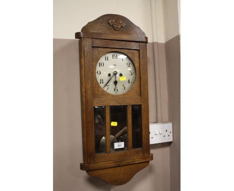 AN EDWARDIAN OAK WALL CLOCK
