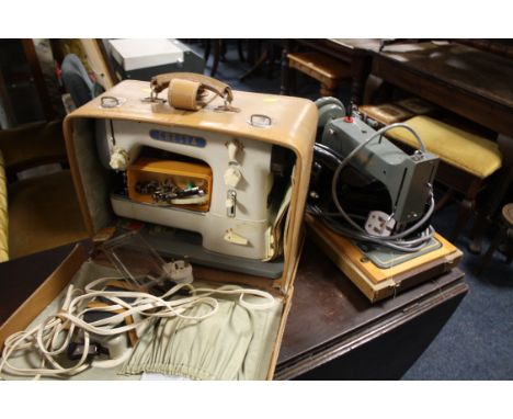 A CASED VINTAGE JONES SEWING MACHINE TOGETHER WITH A CRESTA EXAMPLE