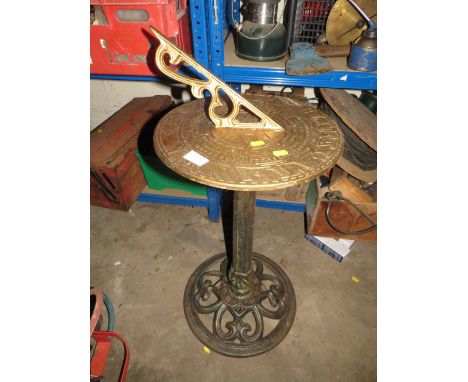 A CAST METAL SUNDIAL WITH GILDED TOP