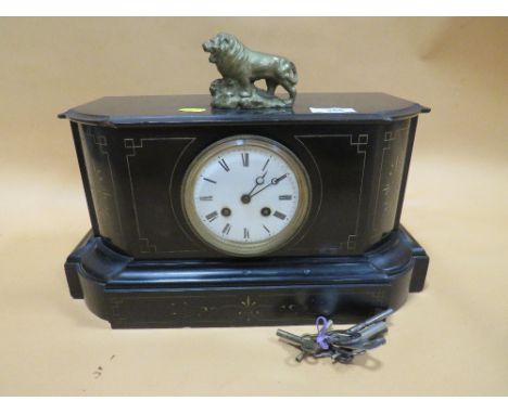 A VINTAGE SLATE MANTEL CLOCK WITH BRASS LION FINIAL 