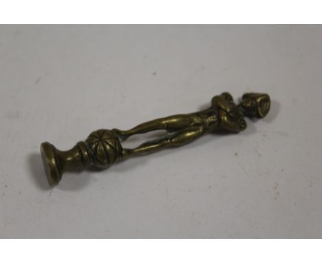 A VINTAGE BRASS PIPE TAMPER IN THE FORM OF NAPOLEON 