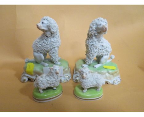 A PAIR OF DRESDEN CERAMIC DOG FIGURES TOGETHER WITH A SMALLER PAIR OF DRESDEN SHEEP FIGURES (4)