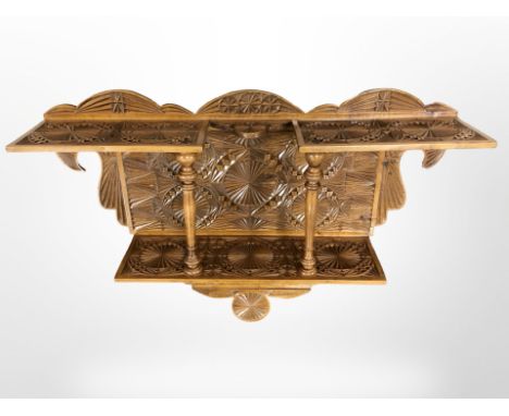 A continental carved two tier wall shelf, width 62 cm  