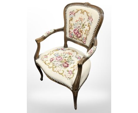 A continental walnut tapestry seated armchair, width 60 cm.