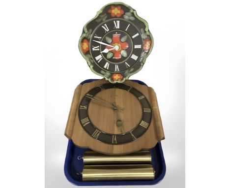 Two Junghans wall clocks and a brass and clear glass oil lamp.