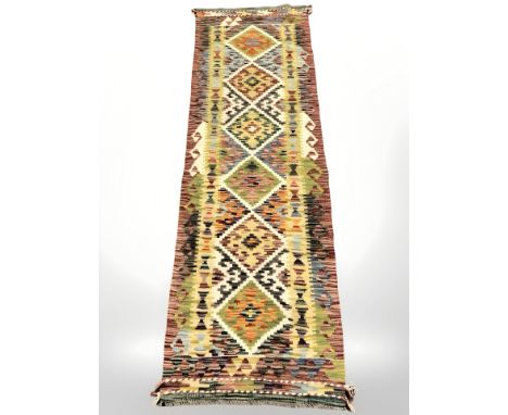 A Chobi Kilim runner, 200 cm x 61 cm.