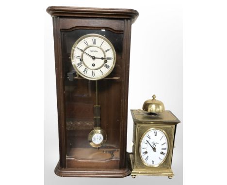 A reproduction wall clock and a brass mantel clock signed 'Angelique'.
