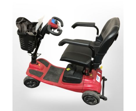 A Vogue mobility scooter with two keys, instructions, charging lead.