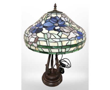 A Tiffany style leaded glass table lamp on patinated metal support, height 57 cm.