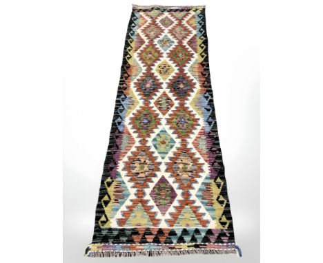 A Chobi Kilim runner, 244 cm x 78 cm.