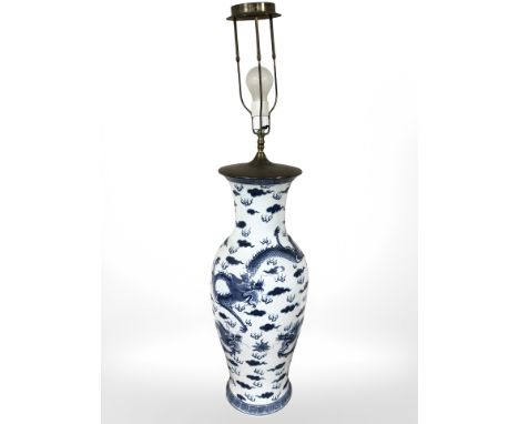 A 20th century Chinese blue and white porcelain baluster vase decorated with four-clawed dragons (converted to a table lamp),