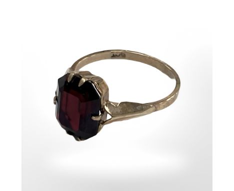 A 9ct yellow gold dress ring set with a synthetic garnet, size K. CONDITION REPORT: 2g.