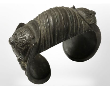 A decorative antique bronze cuff bangle