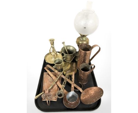 Brass and copper wares including measuring jugs, oil lamp, pestle and mortar.