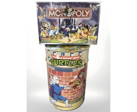 A Teenage Mutant Ninja Turtles metal waste paper bin and a Disney Monopoly game.