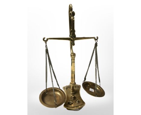 A small brass set of scales with weights, height 24 cm.