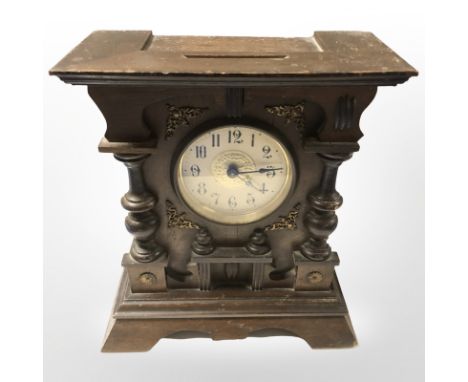 An early 20th century beech mantel clock, height 27 cm.