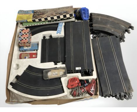 A vintage Scalextric racing set with cars and track.