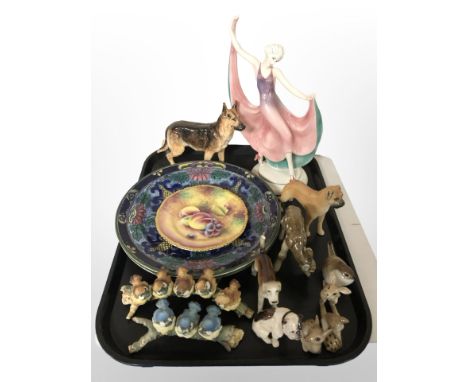 A Royal Worcester porcelain plate painted with fruit by T. Nutt, diameter 15 cm, together with a porcelain figure of a dancer