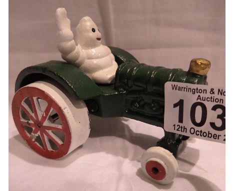 Cast iron Michelin Man on a tractor, H: 80 mm. P&amp;P Group 1 (£14+VAT for the first lot and £1+VAT for subsequent lots) 