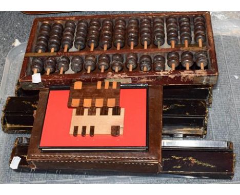 A leather case Mahjong set, together with four chinoiserie tile stands, two gaming counters and an abacus