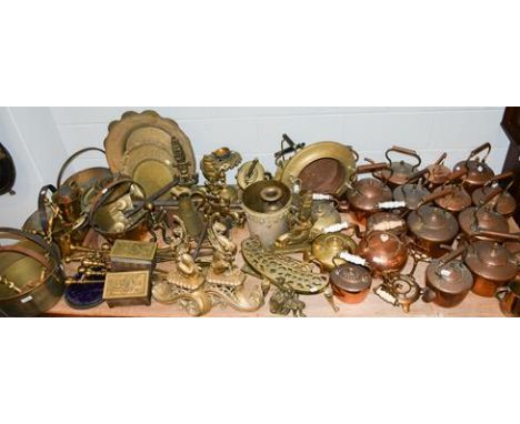 ~ A large quantity of Victorian copper kettles, two brass spirit kettles, a quantity of brass jam pans, trivets, andirons, fi