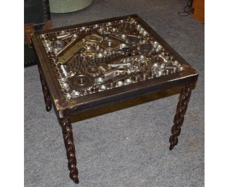 A Steampunk Industrial metal lamp table, constructed using various industrial sprockets, gears, spanners, crank shafts, metal