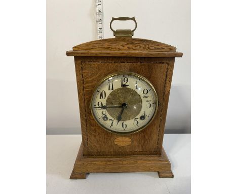 A vintage American wooden cased bracket clock with enamel and brass dial with key and pendulum, shipping unavailable