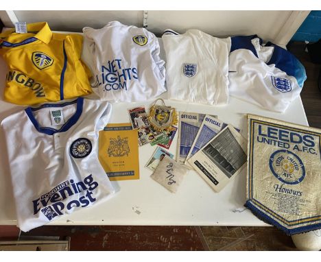 A selection of assorted Leeds United football ephemera including Leeds United and England shirts with patches, programmes etc