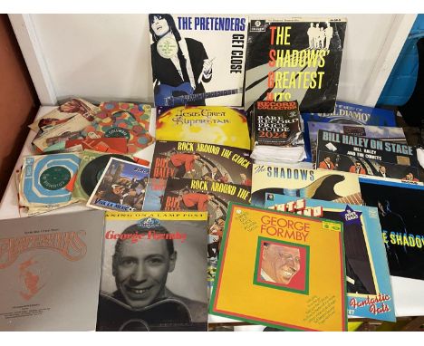 A job lot of mixed genre LP records and singles etc with a record collectors guide book, shipping unavailable