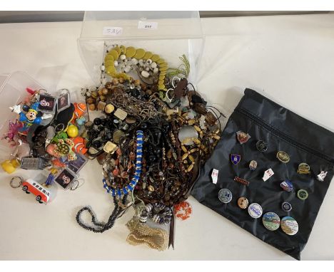 A selection of assorted costume jewellery, enamel badges and key rings etc