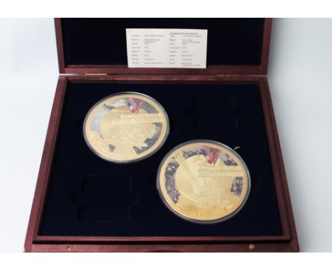 Four gold plated 100 mm Second World War collectors' coins, Battle of Britain, Attack on Pearl Harbour, D Day Landings and Ba