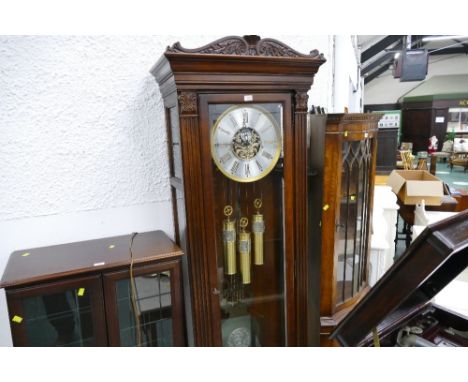 Late 20th/early 21st century Howard Miller mahogany effect longcase clock with Roman numeral dial, ornate pendulum and weight