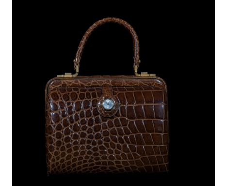 This 1950s handbag is an exquisite example of the sophistication and elegance of the French school of fashion. Crafted from h