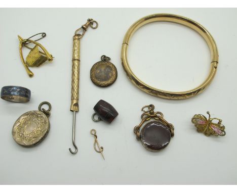 A Wishbone Style Brooch, with "Tasmania" detail, stamped "9", an engine turned gilt coloured button hook, a bangle with flora
