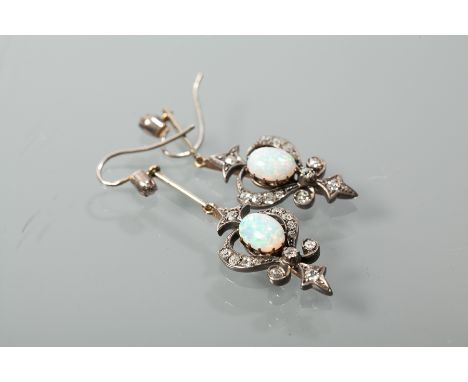 VICTORIAN OPAL AND DIAMOND EARRINGS
of openwork form, each set with a central oval cabochon opal measuring approximately 7.7 