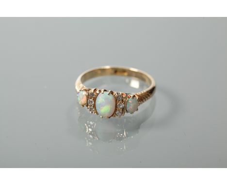 VICTORIAN OPAL AND DIAMOND RING
set with three oval opals interspersed by two lines of diamonds, in a marquise shaped setting