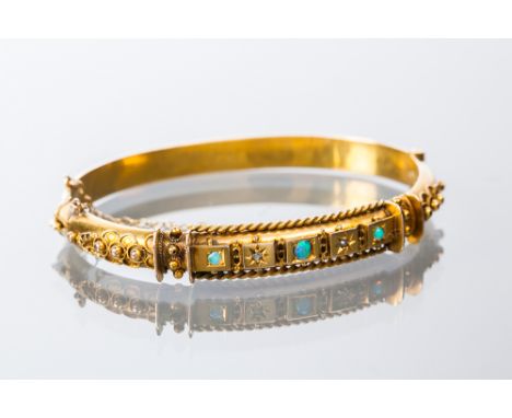 LATE VICTORIAN OPAL AND DIAMOND BANGLE
set with graduated opals interspaced by rose cut diamonds, hallmarked nine carat gold,