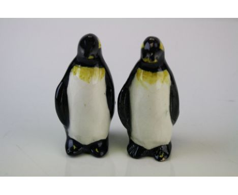 A pair of ceramic penguins with signature to base. Approx 85mm in height. 
