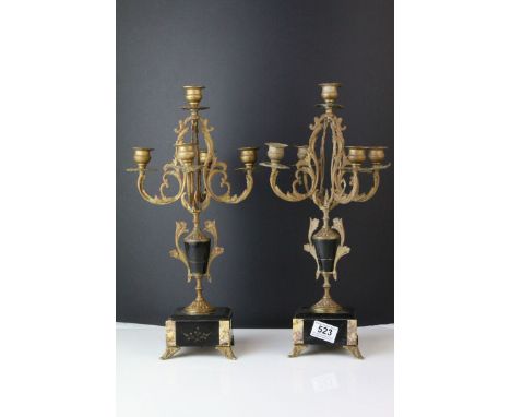 A pair of antique slate and marble and brass candle stick garnitures raised on small brass feet. 