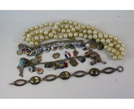 A small collection of vintage Jewellery to include two silver charm bracelets with silver and enamel  charms. 